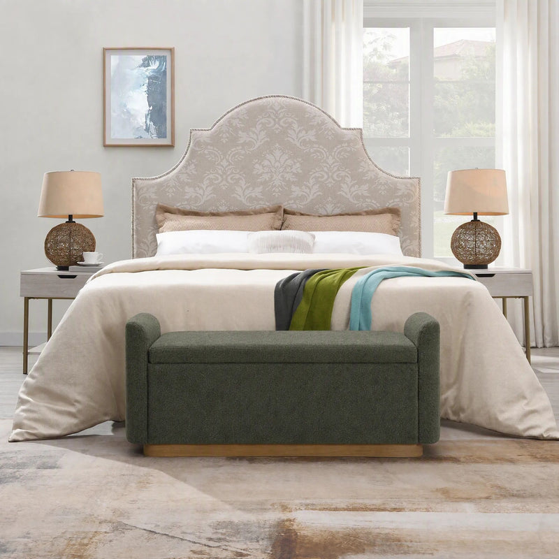 Dark green upholstered storage bench with padded arms and hinged lid.