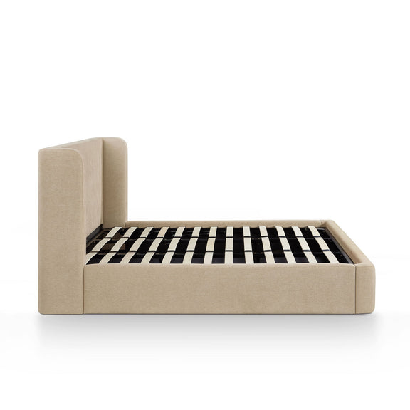 Beige upholstered bed frame with slatted mattress and black-and-white striped cover
