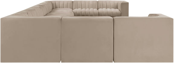 Beige modular sectional sofa with upholstered seats and tufted back cushions