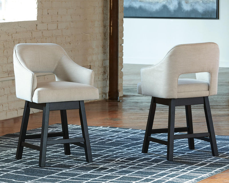 Beige upholstered swivel barstool pair with padded seats and dark wooden bases