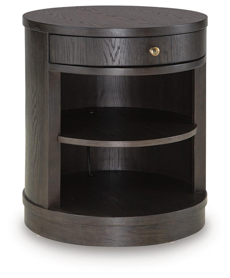 Round dark brown accent table with lower open shelf and single drawer with brass knob