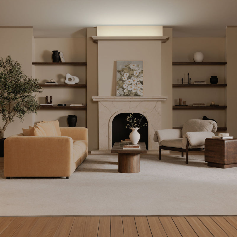 Beige lounge chair in living room, upholstered arms and seat with dark wood frame