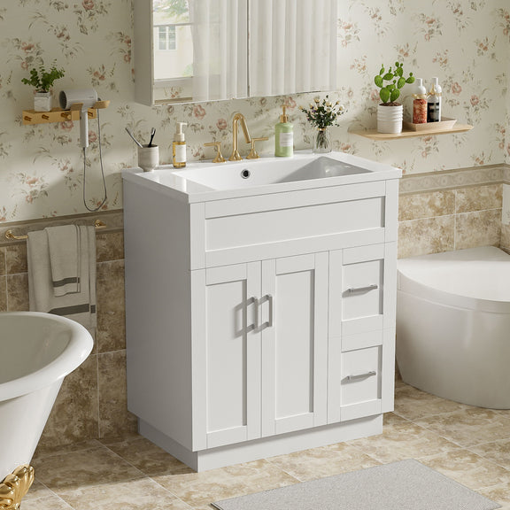 White bathroom vanity with sink and central drawer, flanked by cabinet doors, bar pulls