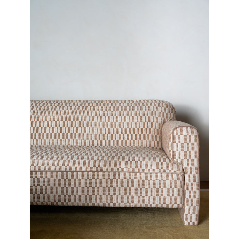 Taupe patterned sofa corner view with rolled armrest and seat cushions