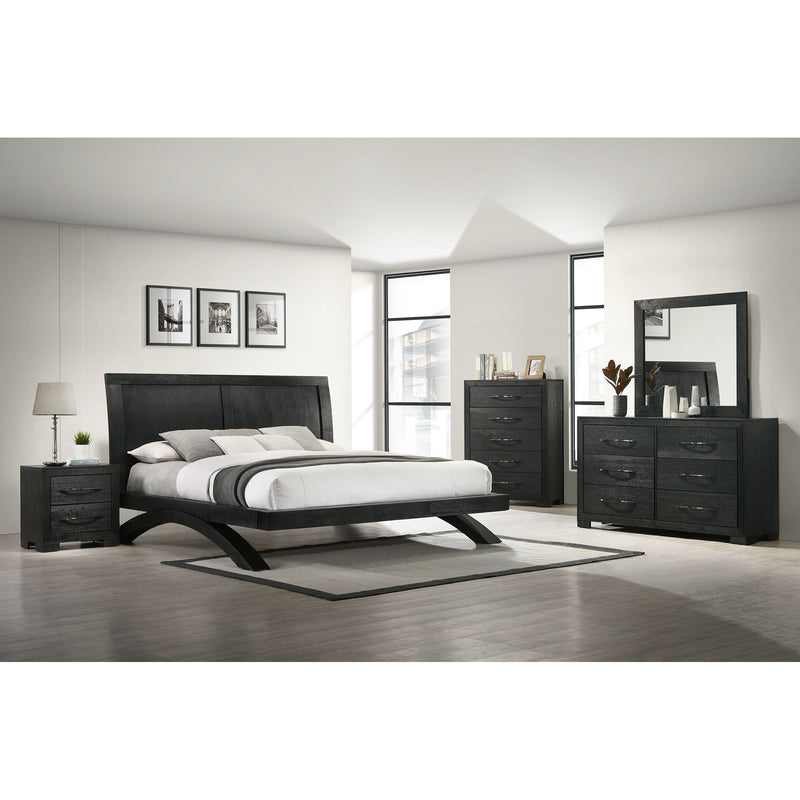 Black panel bedroom set with bed, dresser, mirror, chest, and nightstands.