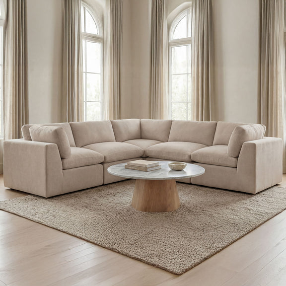 Light beige L-shaped corner sectional sofa with padded arms and deep seat cushions