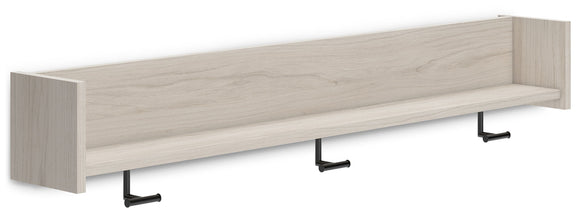 Corner view of wall-mounted coat rack with light natural wood shelf and three hooks