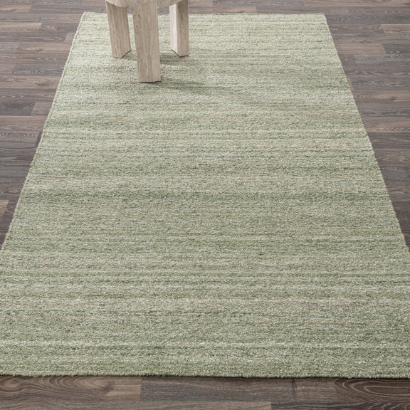 Large sage green textured area rug with horizontal stripes under table