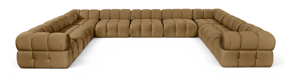 Tan velvet upholstered sectional sofa with tufted cushions and curved corner arms