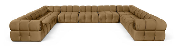 Tan velvet upholstered sectional sofa with tufted cushions and curved corner arms