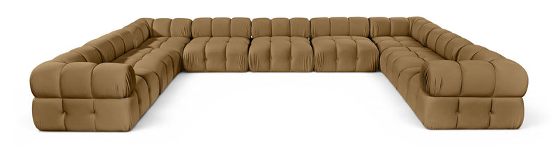 Tan velvet upholstered sectional sofa with tufted cushions and curved corner arms