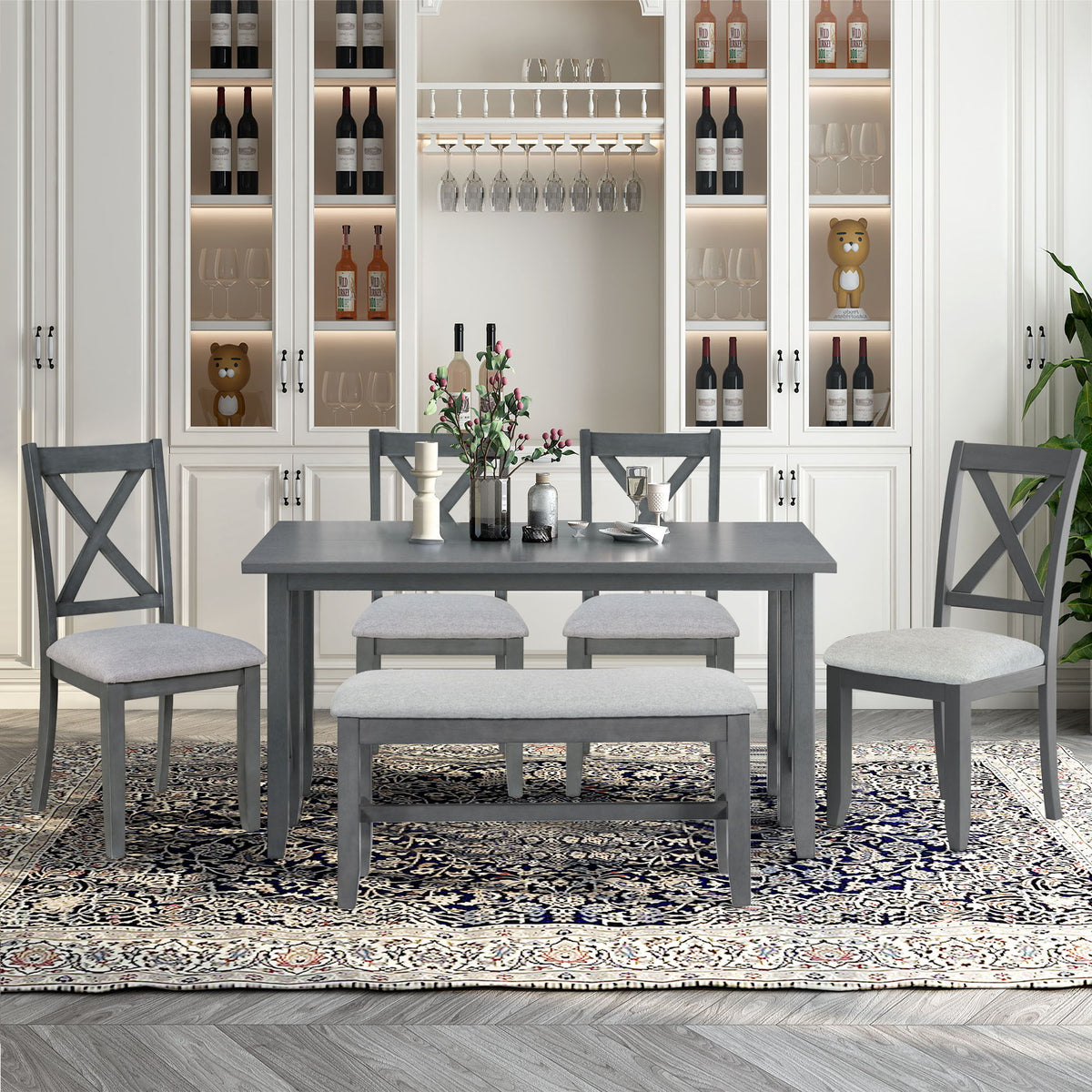 Gray dining table with four cross-back chairs and upholstered bench seating set