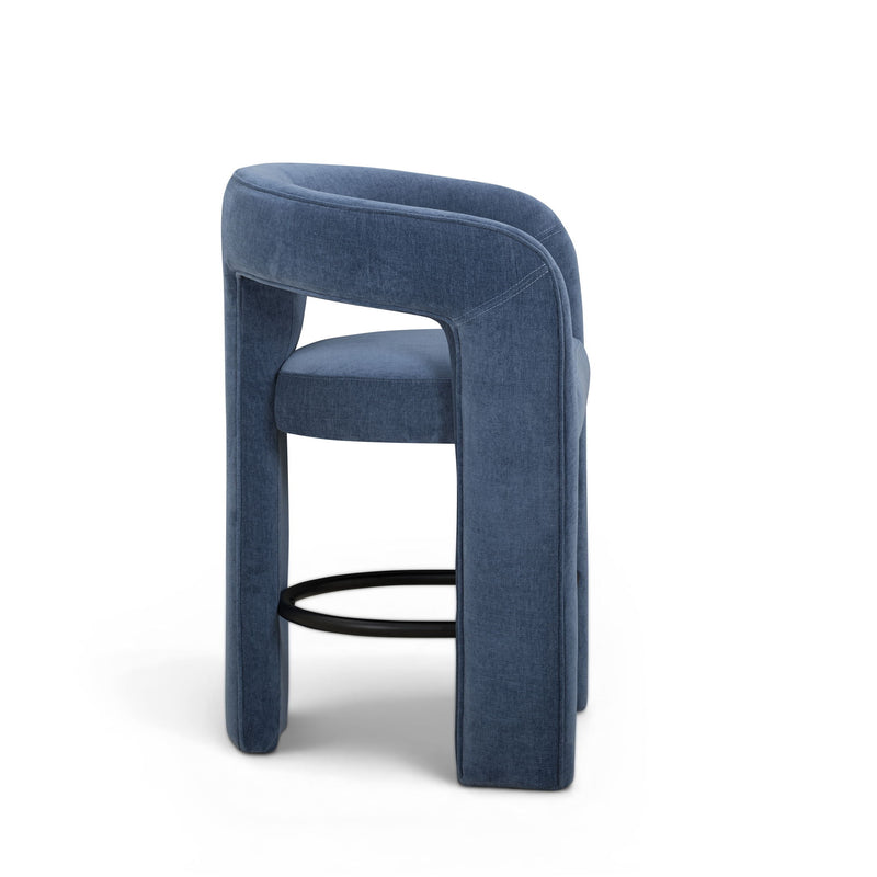 Blue upholstered stool angled side view with black metal footrest