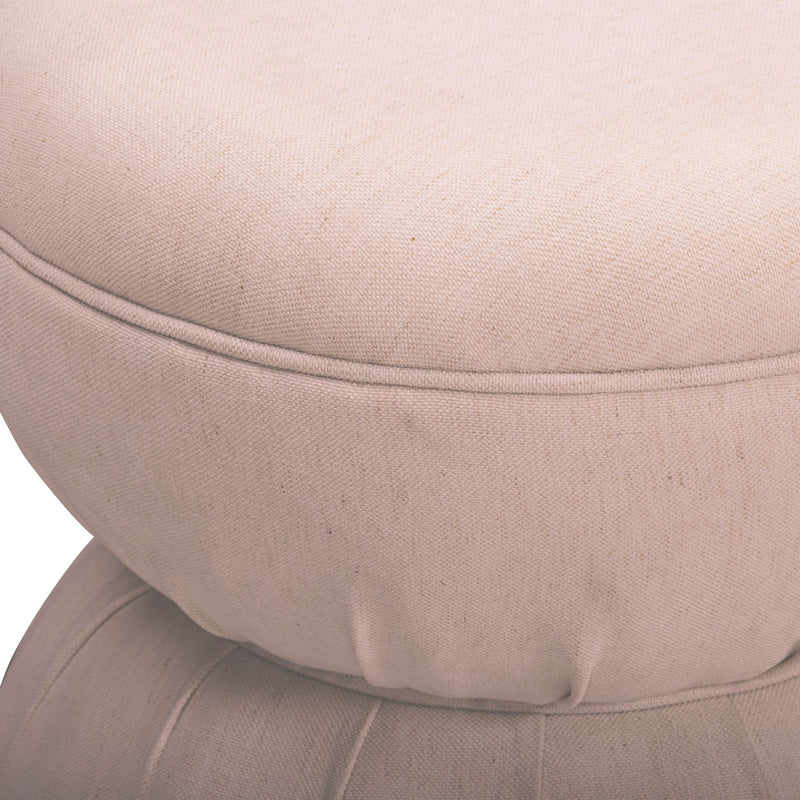 Close-up of light pink-beige ruched upholstered ottoman with stitched seam