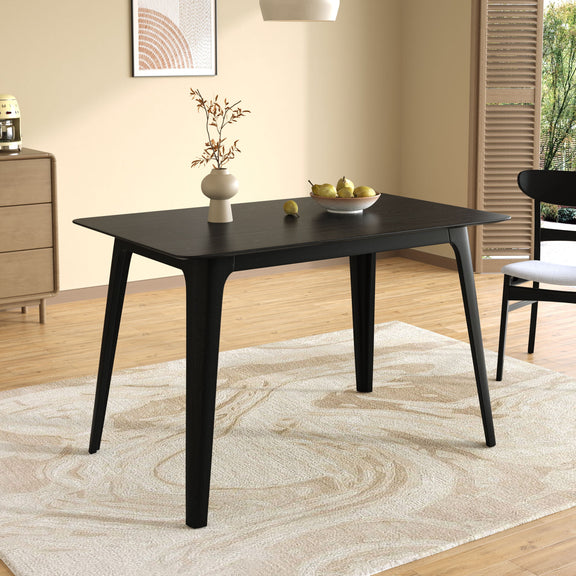 Black dining table with tapered legs, square corners, and tabletop finish