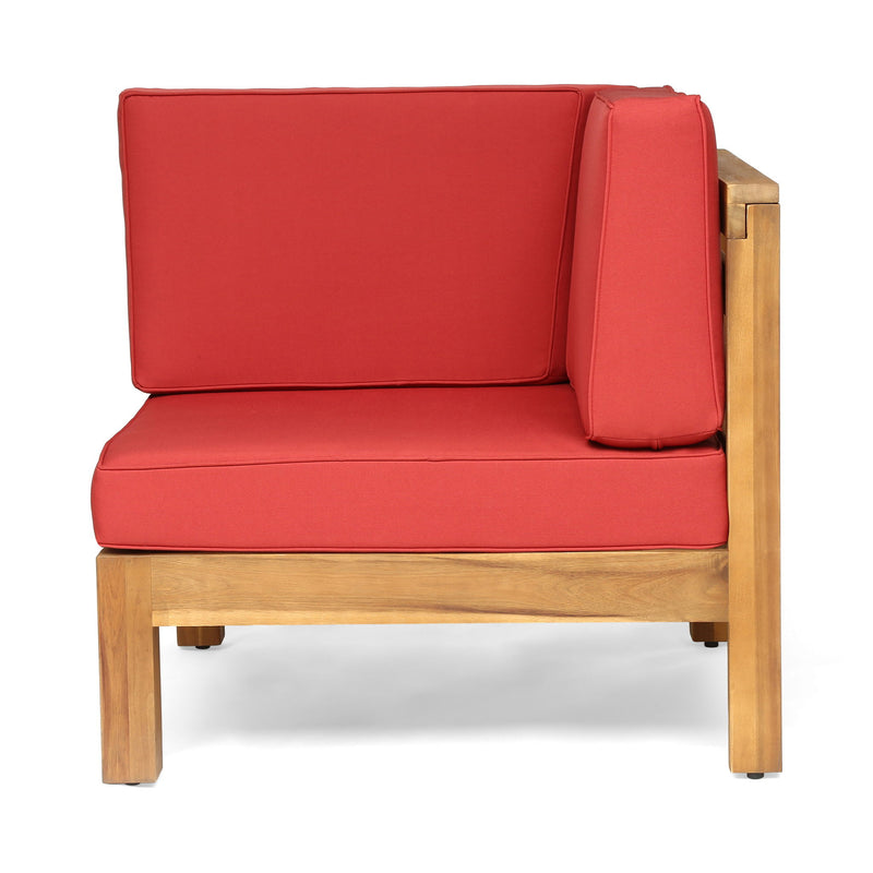 Outdoor love seat with red cushions and light wood armrests, close side view