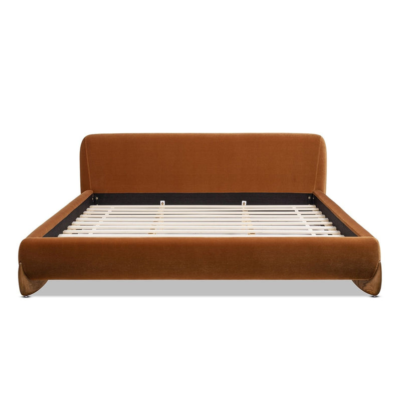 Modern platform bed in warm orange-brown with upholstered headboard and slatted base