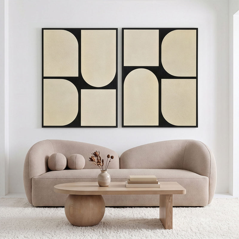Two-piece wall art set with black frames and beige abstract rounded panels.
