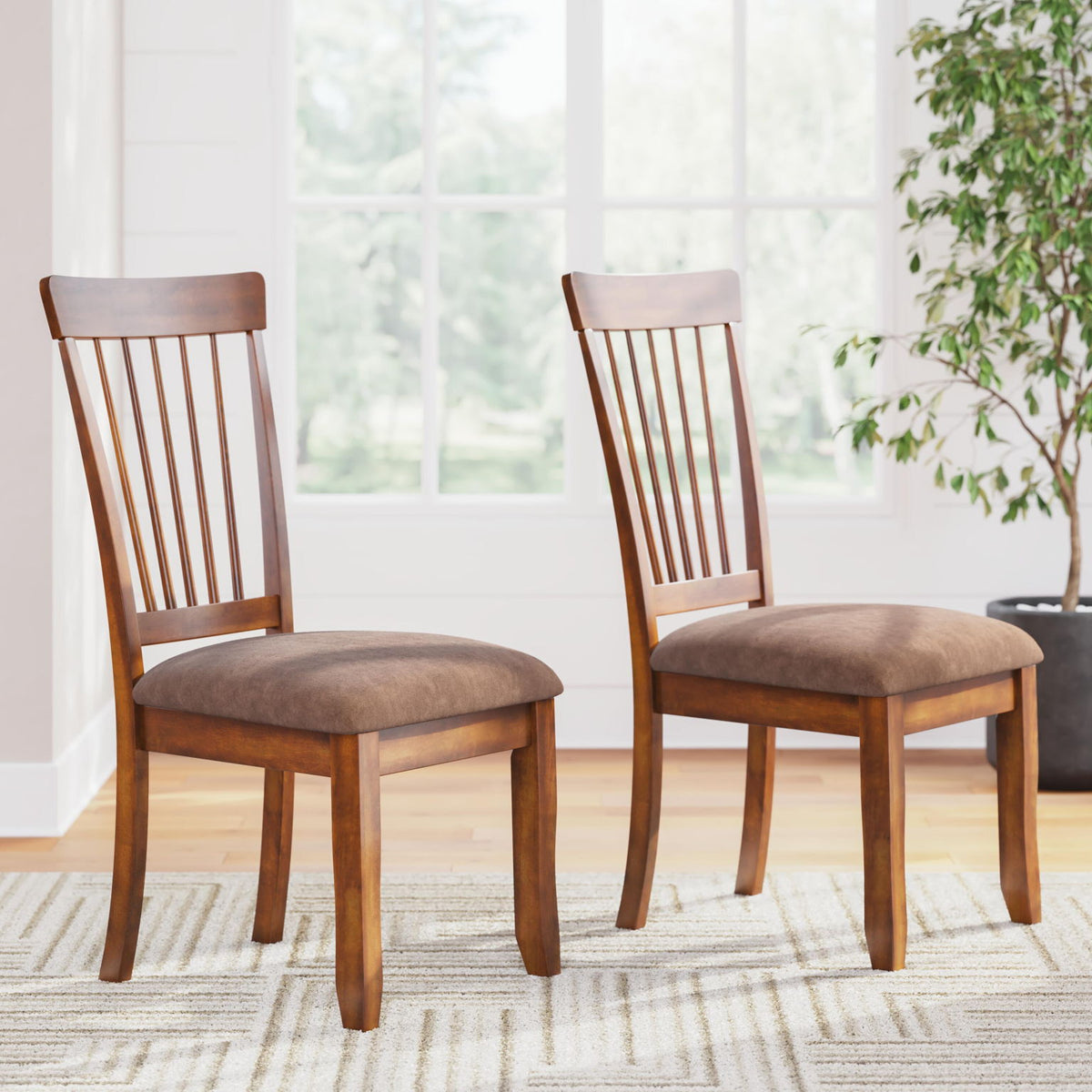 Two dining side chairs with vertical slat backs and upholstered seats in rustic brown