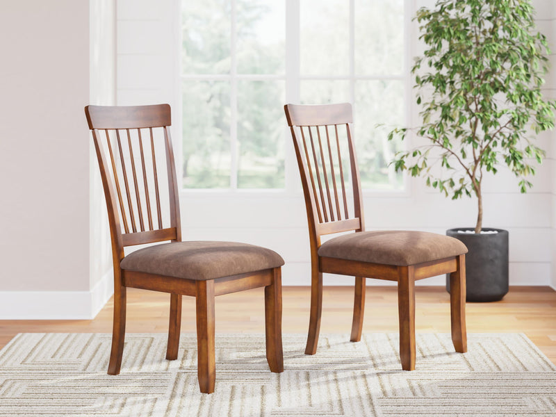 Two dining side chairs with vertical slat backs and upholstered seats in rustic brown