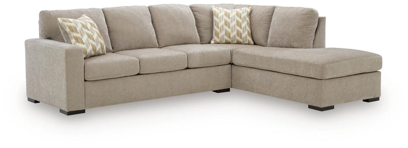 Sleeper sectional sofa with corner chaise, taupe upholstery, two patterned accent pillows