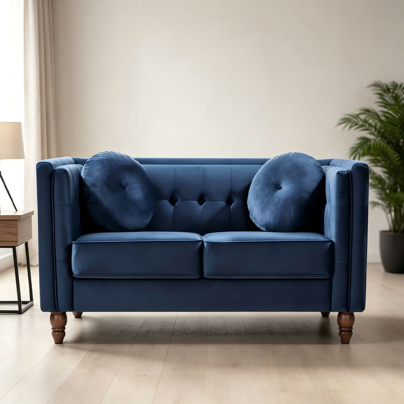 Blue 2-seater velvet loveseat with tufted back and round accent pillows