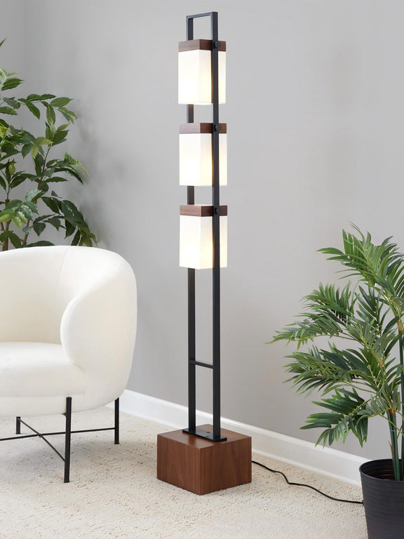 Black standing lamp with three white cube shades on a vertical metal frame
