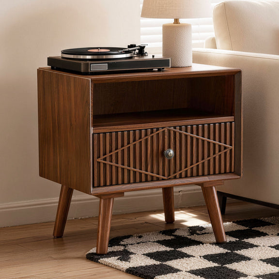 Walnut nightstand with one carved drawer and open shelf, shown with a turntable on top