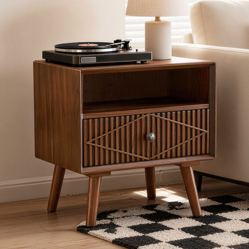 Walnut nightstand with one carved drawer and open shelf, shown with a turntable on top