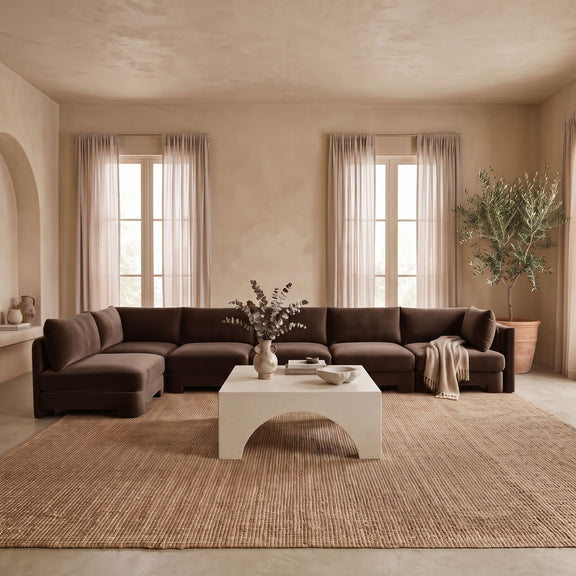 Dark brown L-shaped armless sectional sofa with velvet-style upholstery and matching cushions