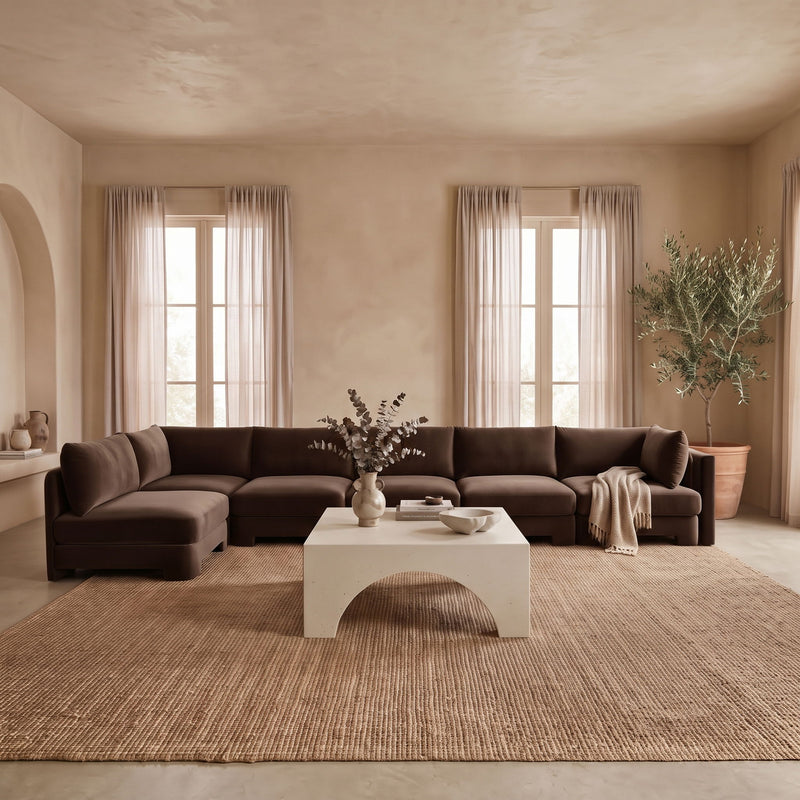 Dark brown L-shaped armless sectional sofa with velvet-style upholstery and matching cushions