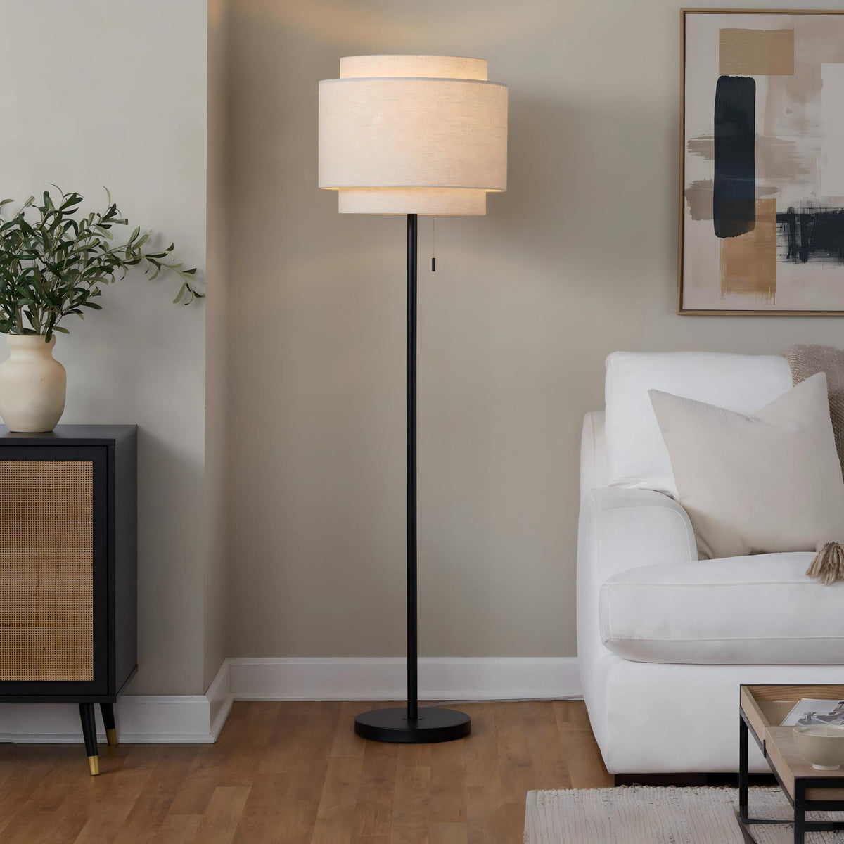 Black contemporary floor lamp with off-white fabric drum shade and round base