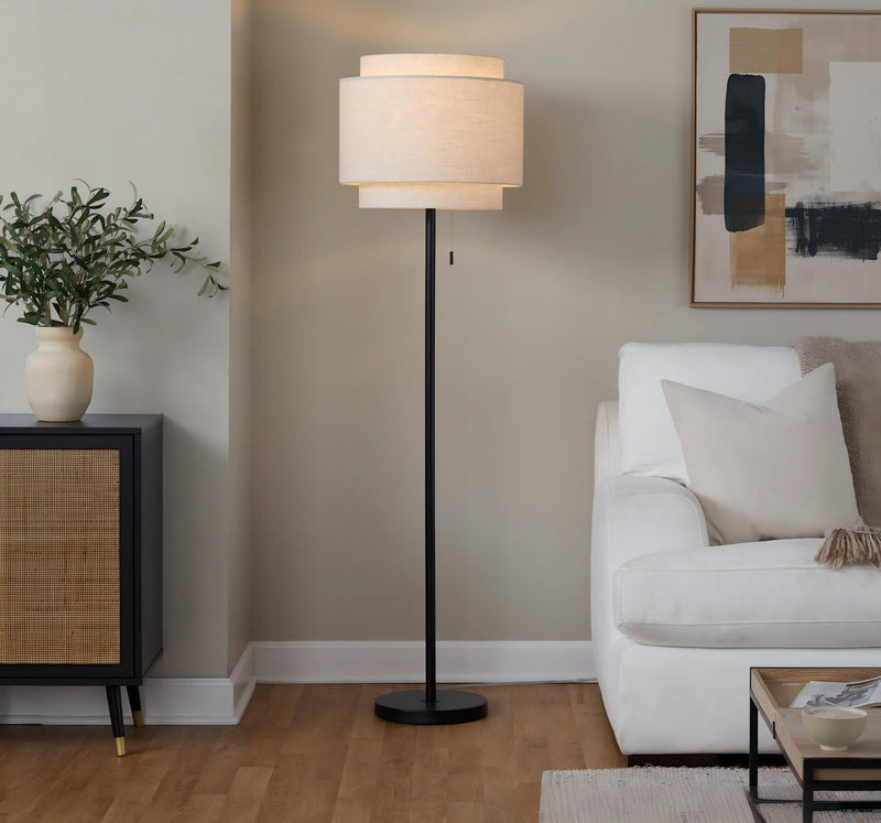 Black contemporary floor lamp with off-white fabric drum shade and round base