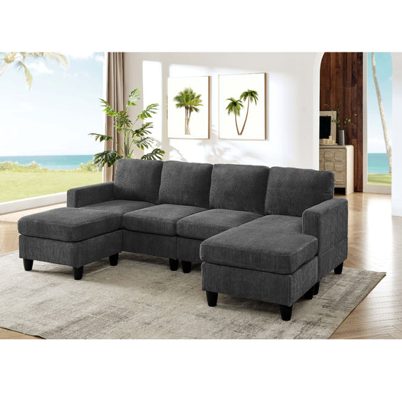 Dark gray modular sectional sofa with two ottomans, padded arms, and tufted cushions