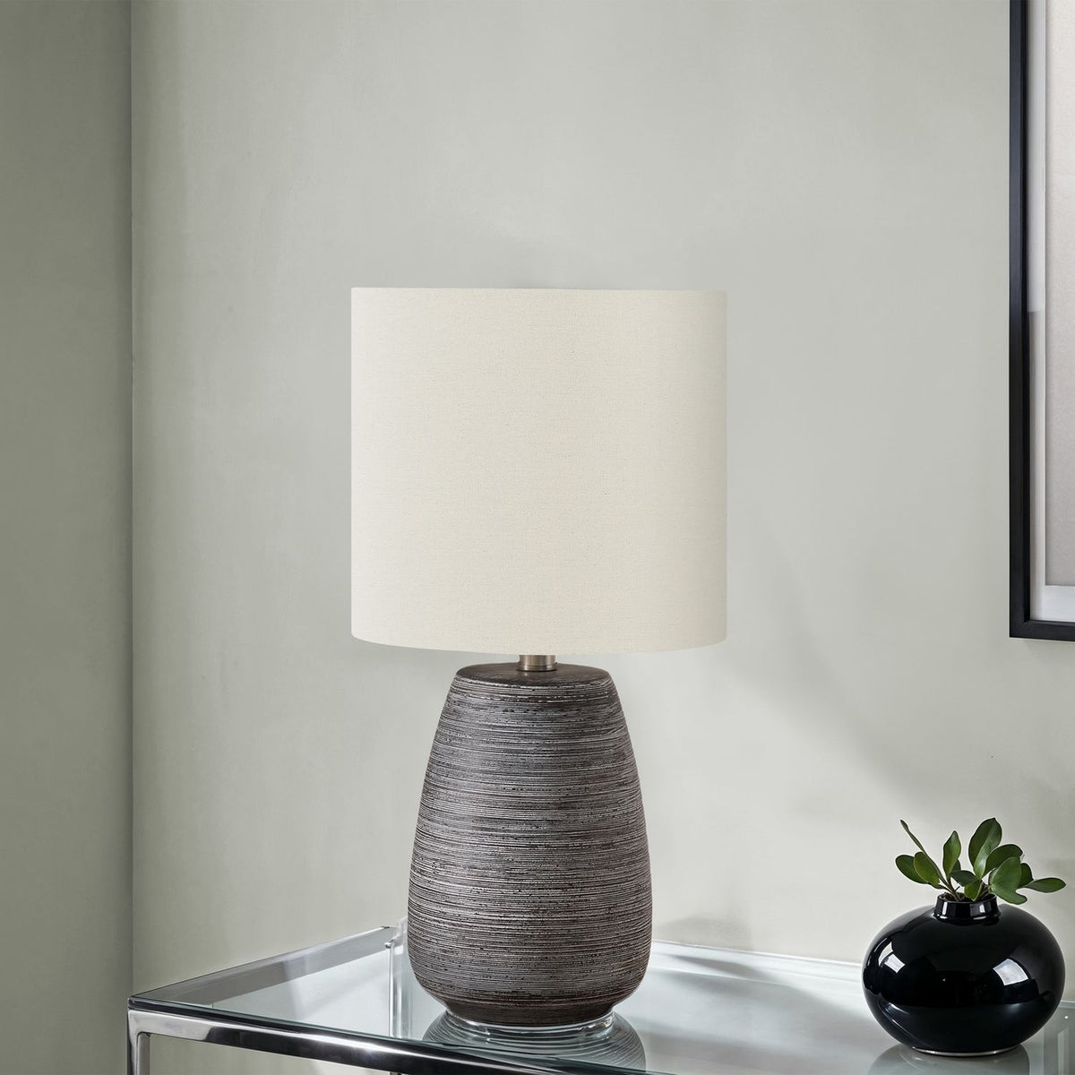 Ceramic table lamp with gray textured base and cream square fabric shade
