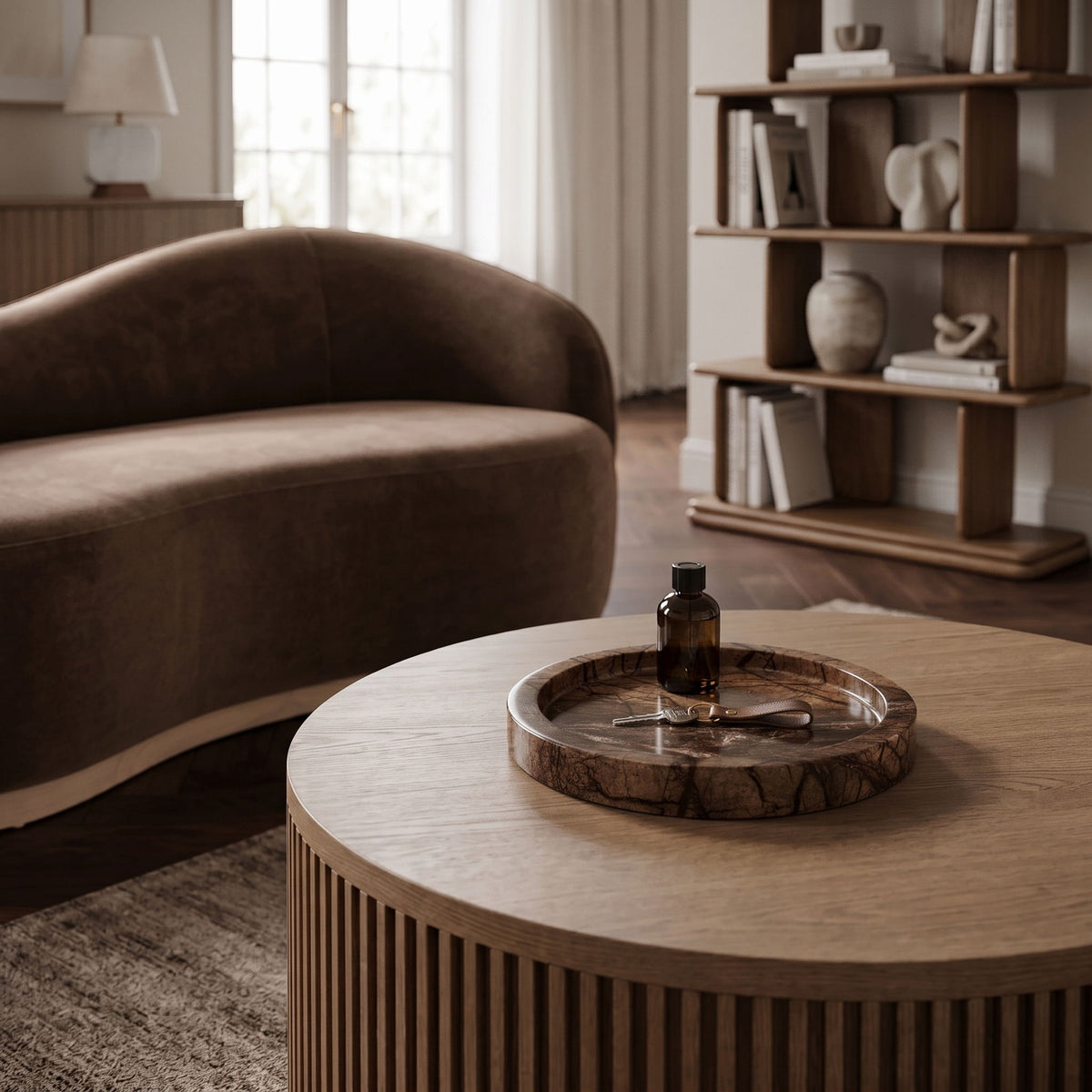 Round marble tray on a table, showing clear veining and shallow basin