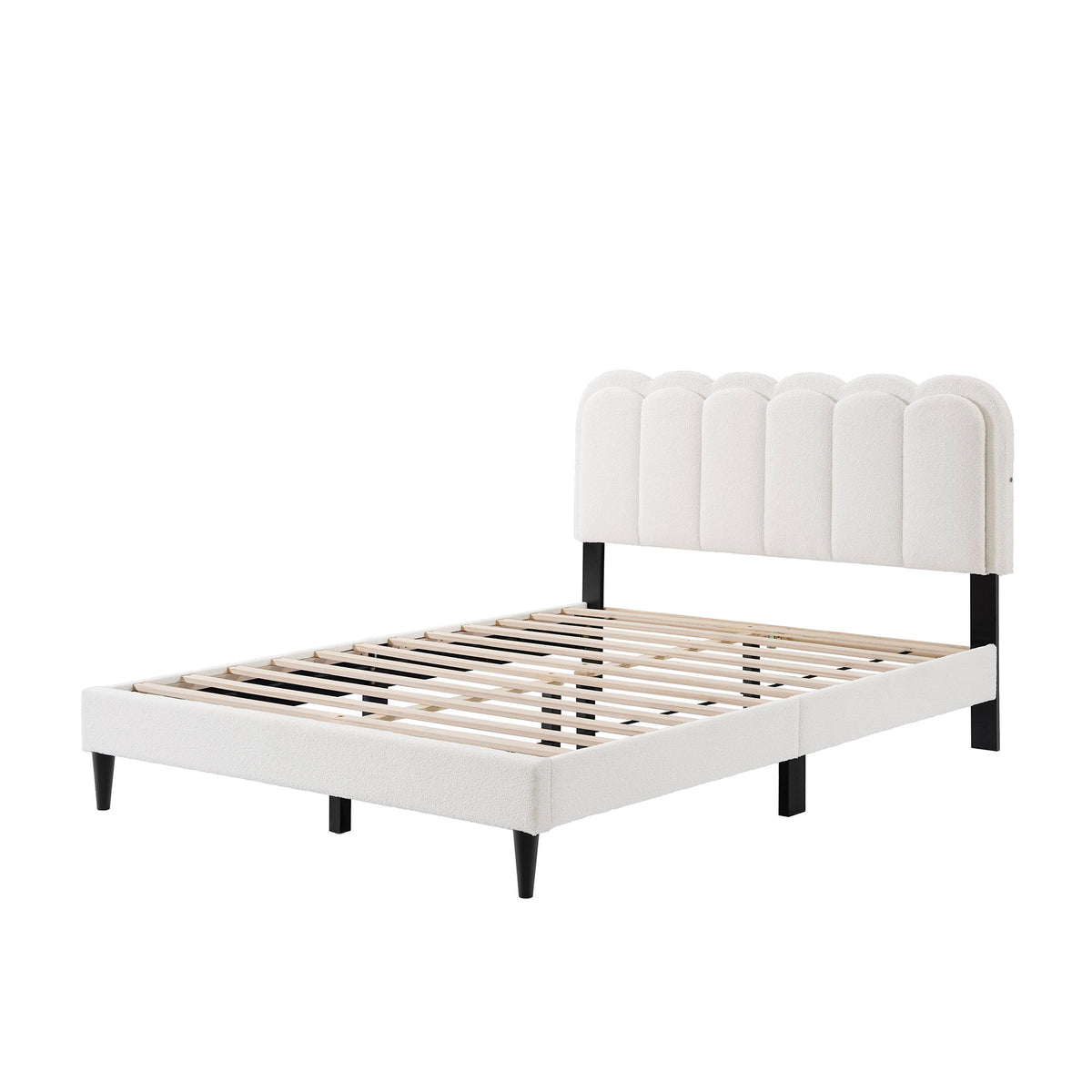 White upholstered scalloped headboard queen bed frame with slatted platform and dark legs