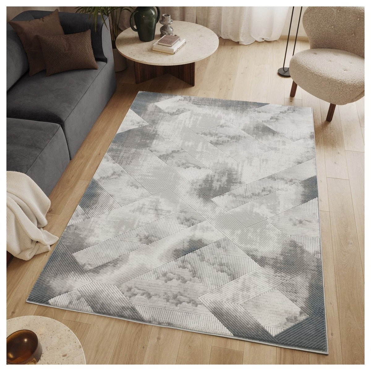 Gray geometric rug with raised diamond-and-cross pattern, shown in a living room