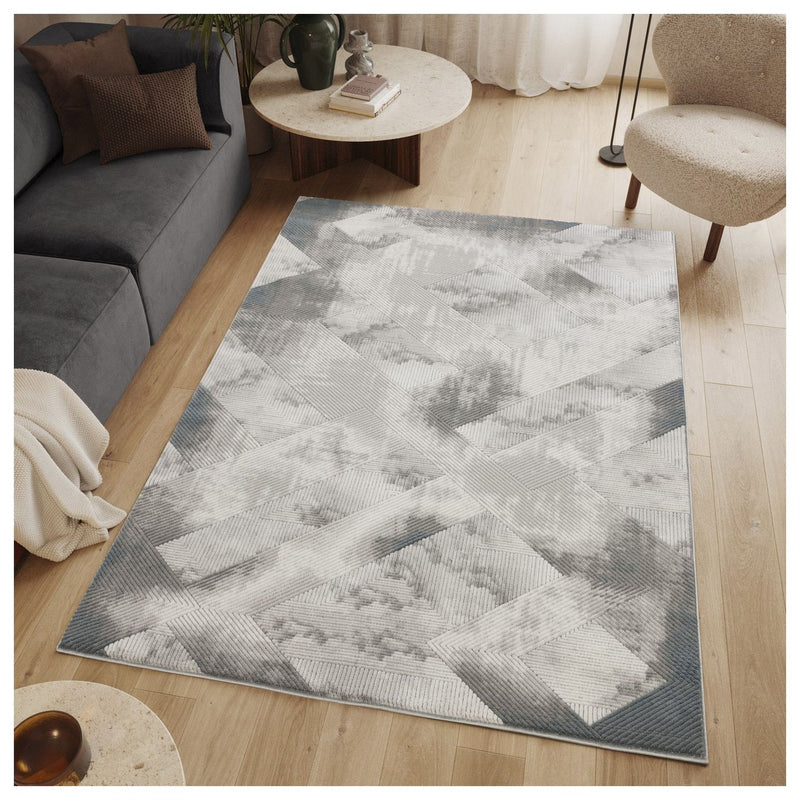 Gray geometric rug with raised diamond-and-cross pattern, shown in a living room
