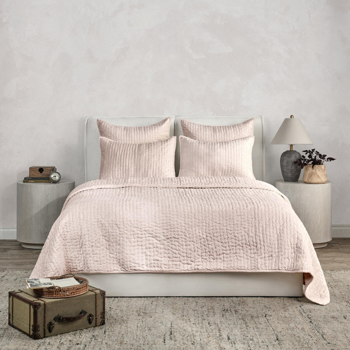 Ivory velvet quilt set with textured quilt and matching shams on a bed