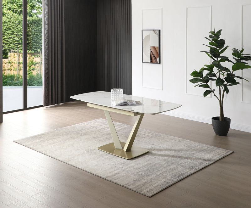 Dining table with glossy white marble-look top and gold pedestal base, floor view