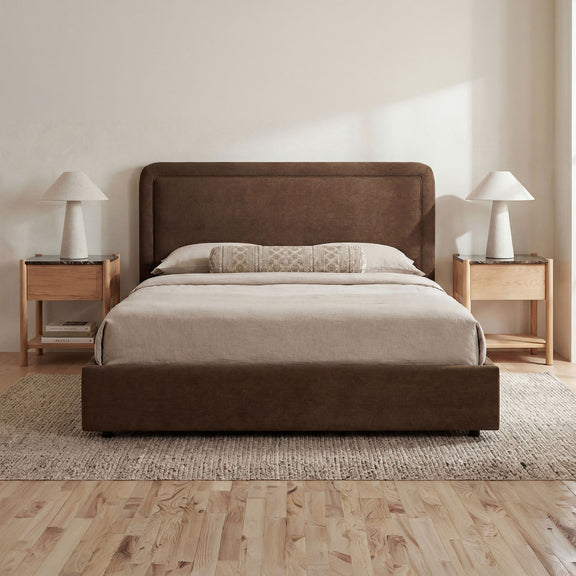 Brown queen storage bed with tall upholstered headboard and cushioned platform base