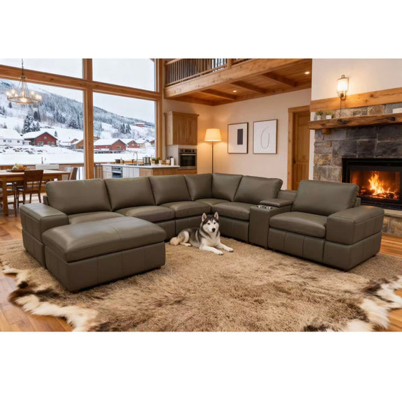 Dark green modular sectional sofa with large square arms and extended chaise ottoman