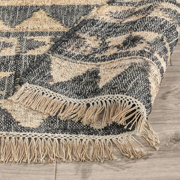 Solana rug in distressed black and natural with zigzag pattern and short fringe edge.