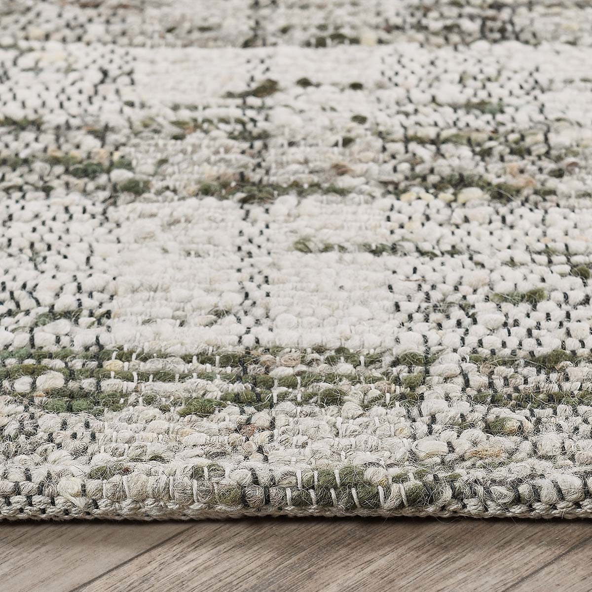 Textured area rug with speckled light gray weave and short fringed edge detail