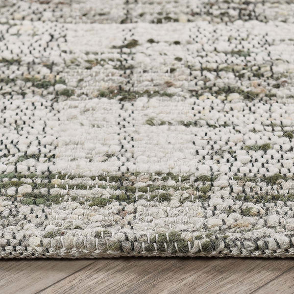 Textured area rug with speckled light gray weave and short fringed edge detail