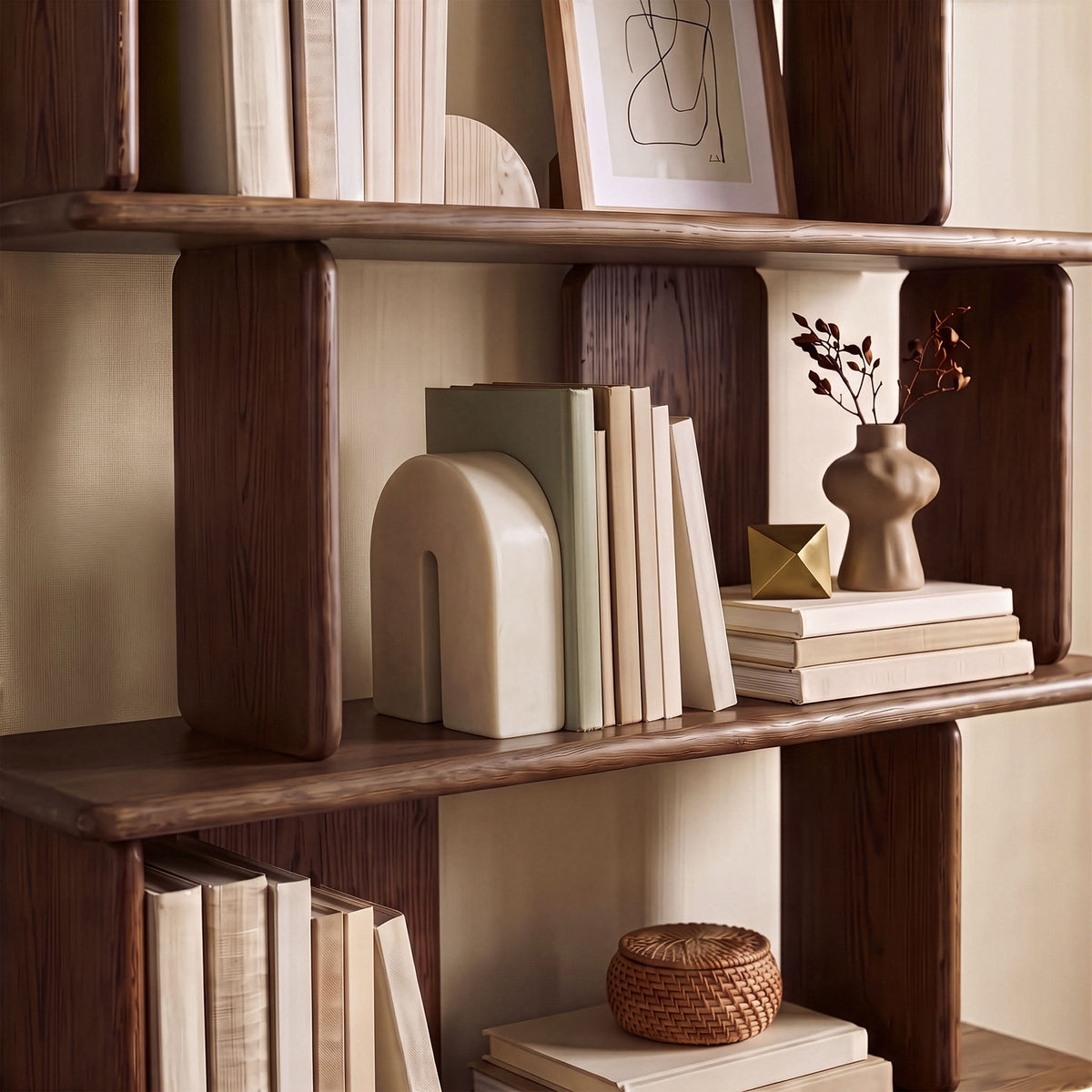 Cream marble bookend with arched cutout, placed on wooden shelf