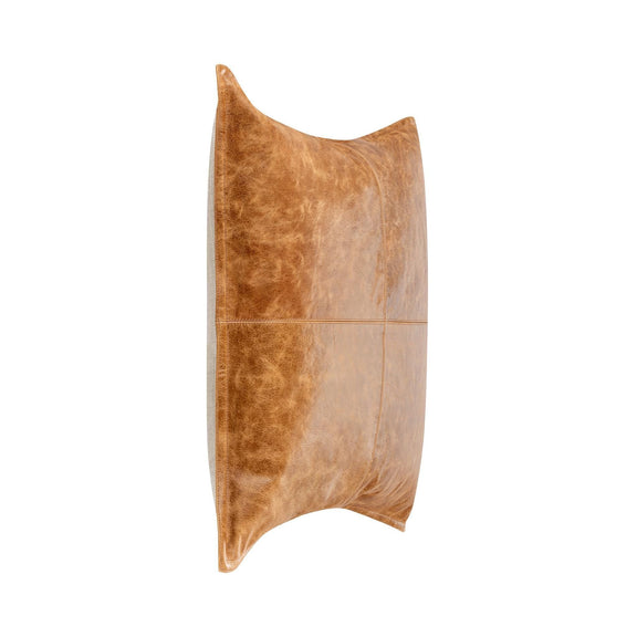 Tan leather lumbar pillow shown from the side with center seam detail.