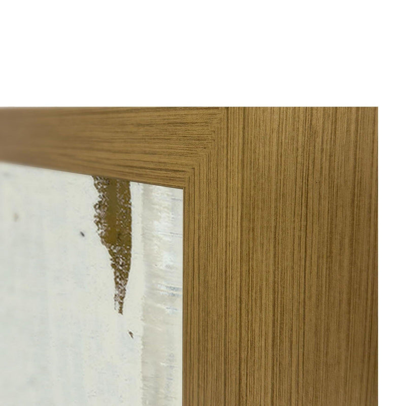 Close-up of light wood frame corner and white painting edge with gold undertones