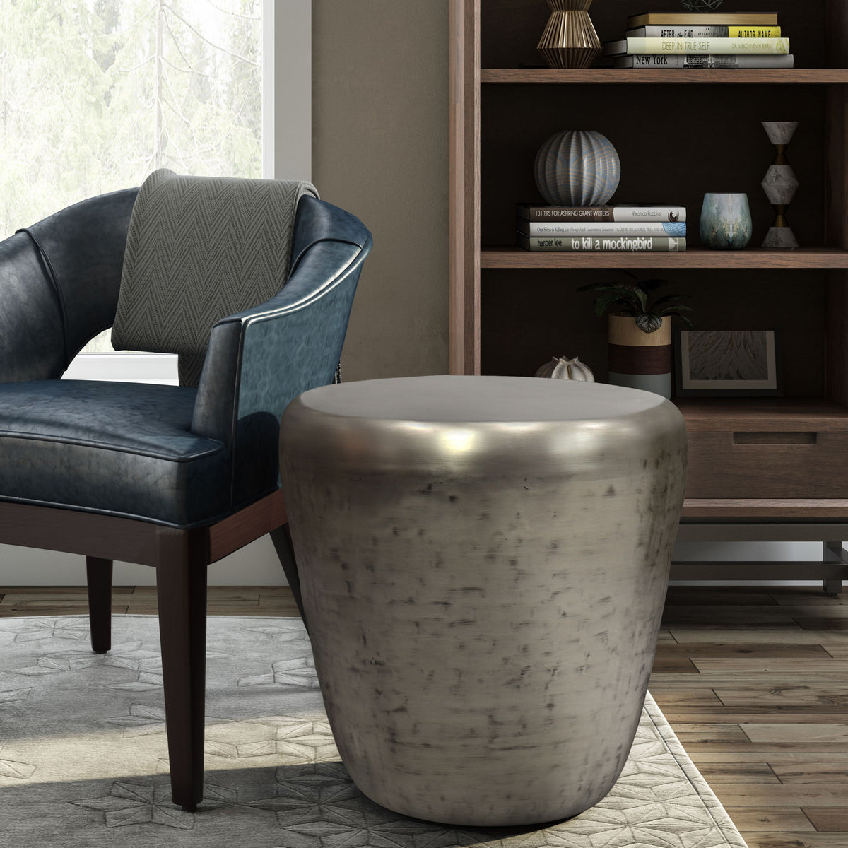 Handcrafted metal side table in pearl silver, hammered drum design with rounded top.